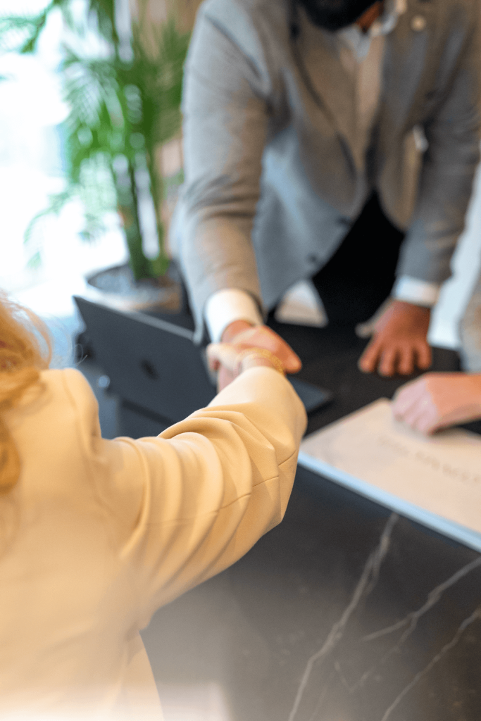 Business handshake across office desk symbolizing successful partnership agreement